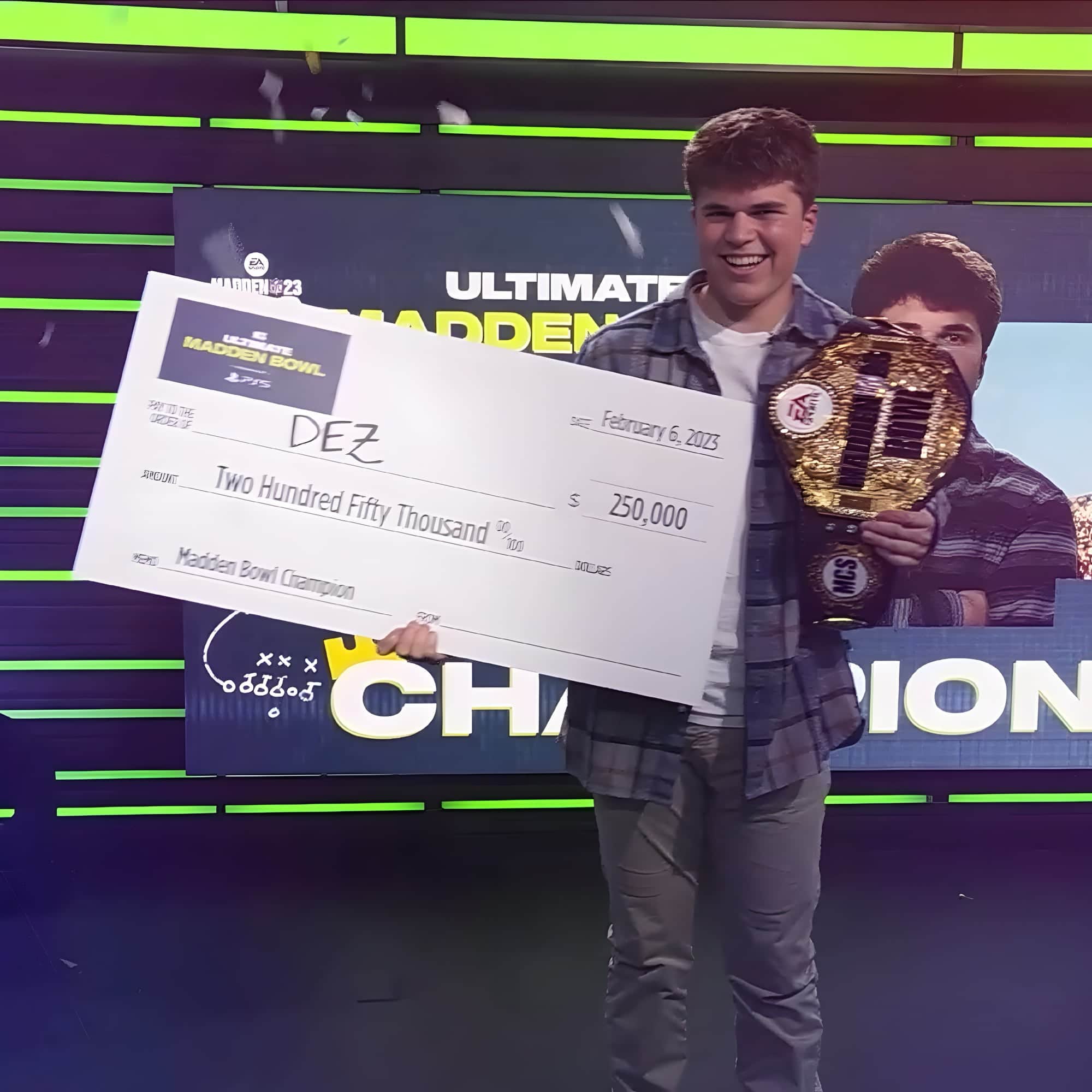 Dez holding his Madden championship belt and prize check.