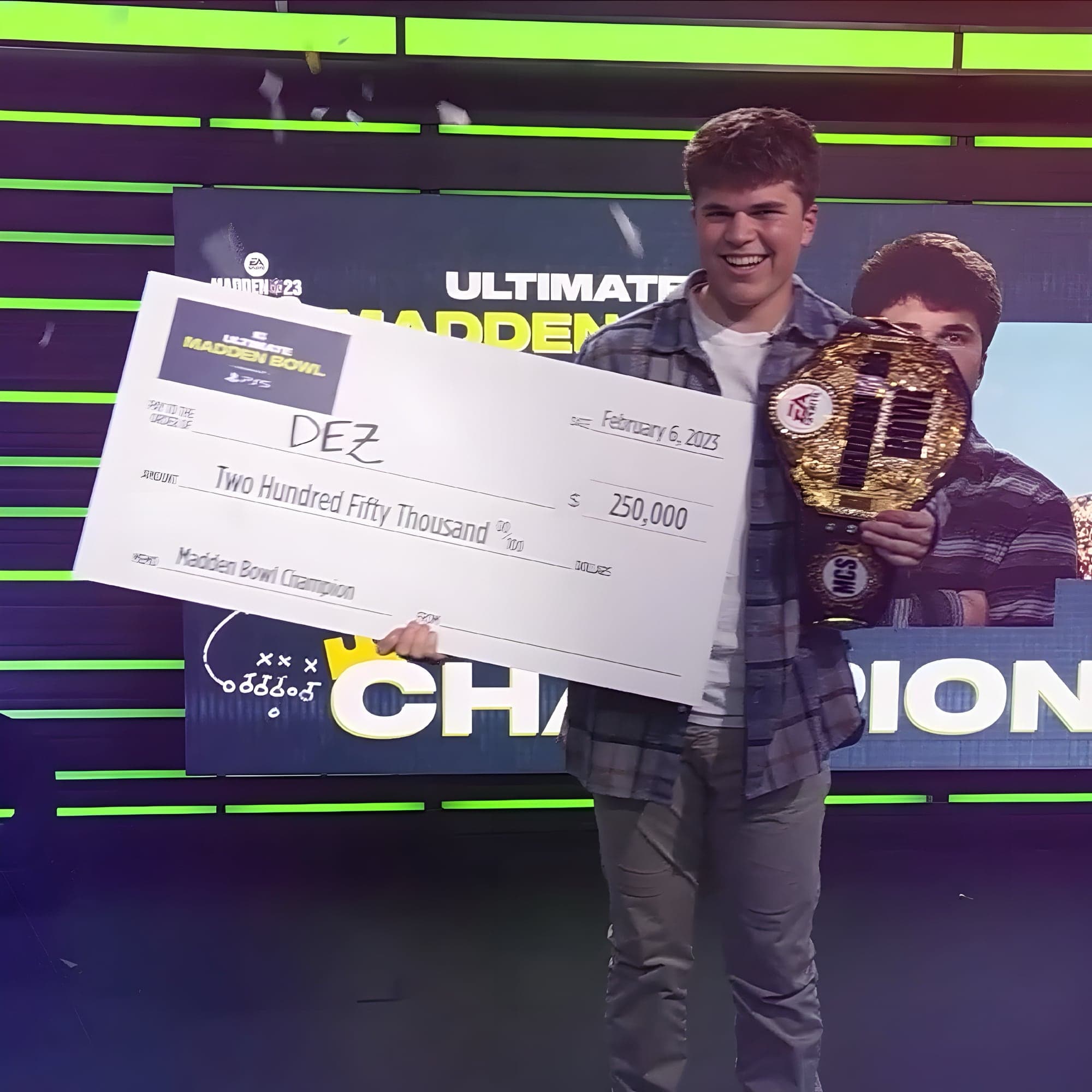 Dez holding his Madden championship belt and prize check.